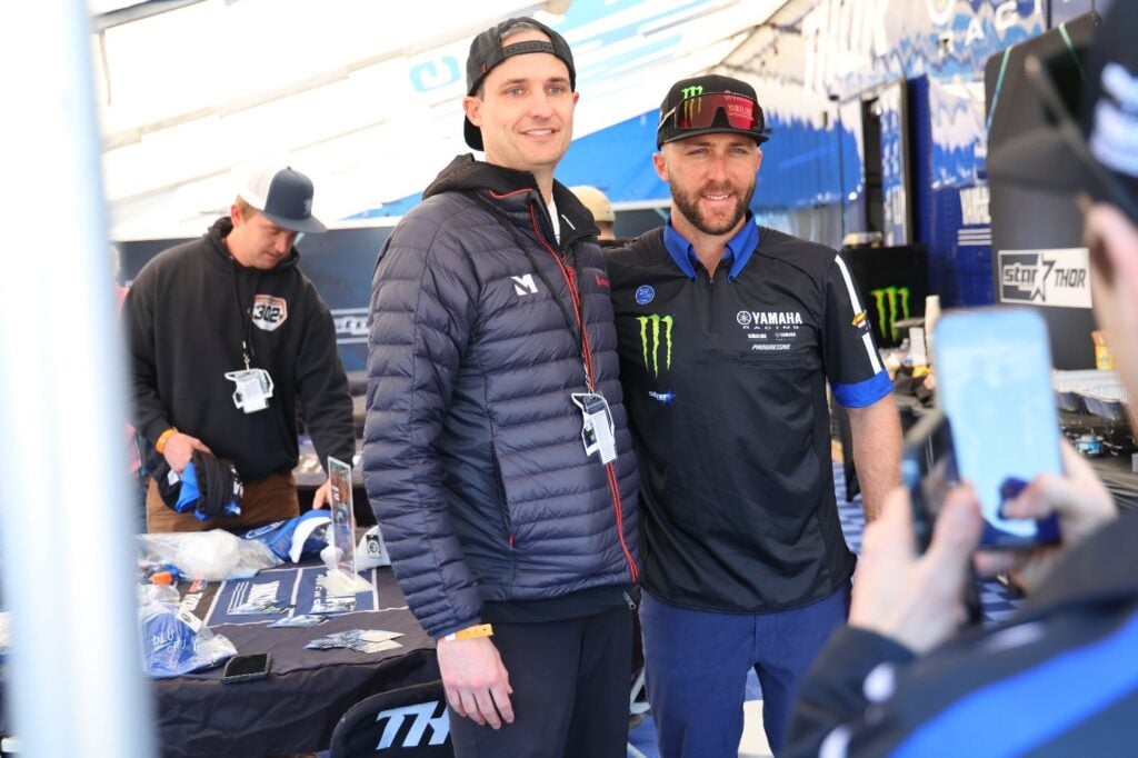 Eli Tomac posing with a VIP Experience Fan who got to spend the day with the Monster Energy Yamaha Star Racing Team during this all-inclusive fan experience.